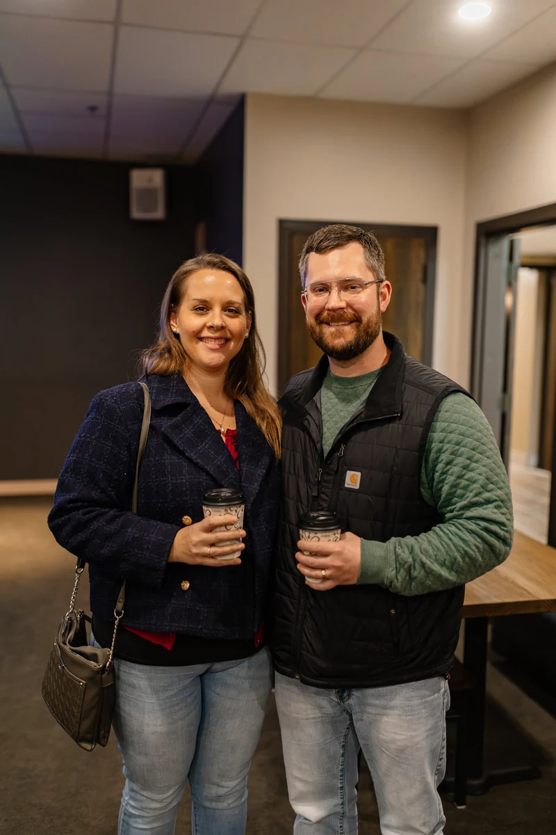 Two people smiling with coffee at New Life Community Church.